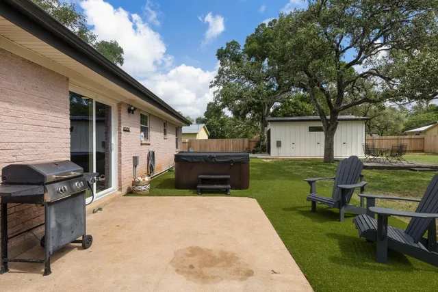 a view of backyard of house with outdoor seating