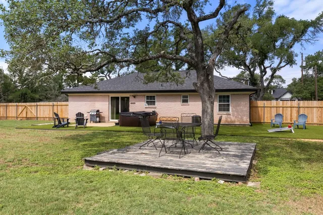 a front view of a house with a yard balcony and outdoor seating