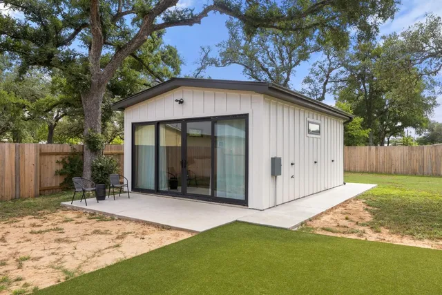 a front view of a house with a garden and yard