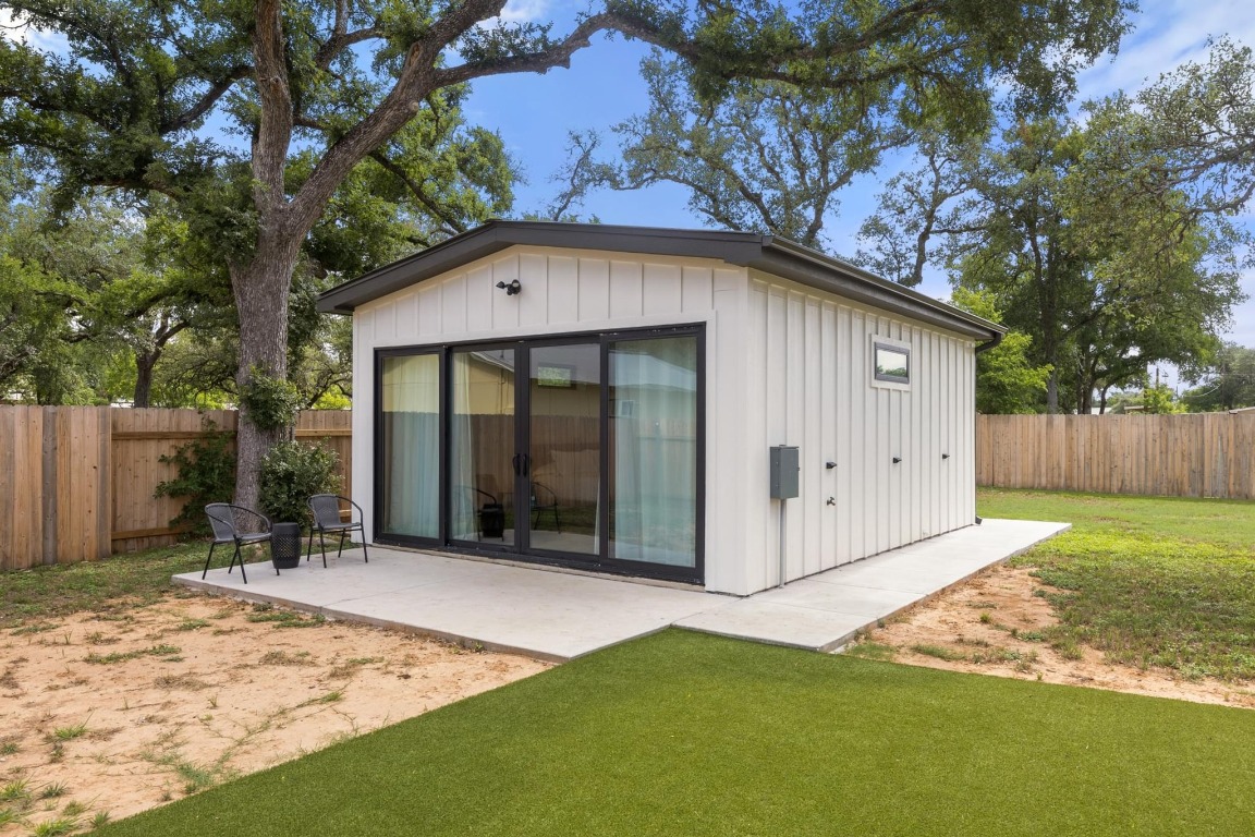 219 Bluff Street Dripping Springs, TX 78620 - Photo 22 of 40 a front view of a house with a garden and yard