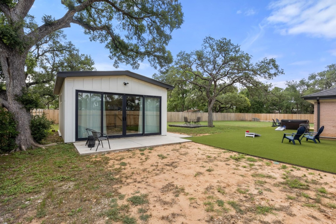 219 Bluff Street Dripping Springs, TX 78620 - Photo 23 of 40 a view of a house with backyard and a tree