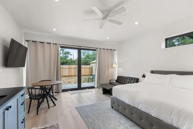 a bedroom with a bed and a large window