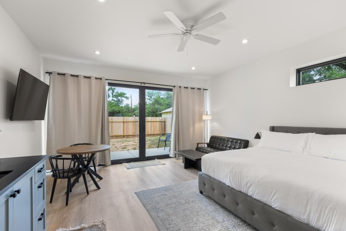 219 Bluff Street Dripping Springs, TX 78620 - Photo 24 of 40 a bedroom with a bed and a large window