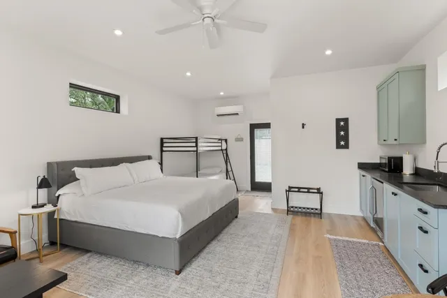 a bedroom with a large bed and a chandelier