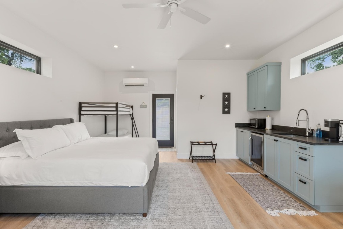 219 Bluff Street Dripping Springs, TX 78620 - Photo 28 of 40 a spacious bedroom with a bed a table and chair