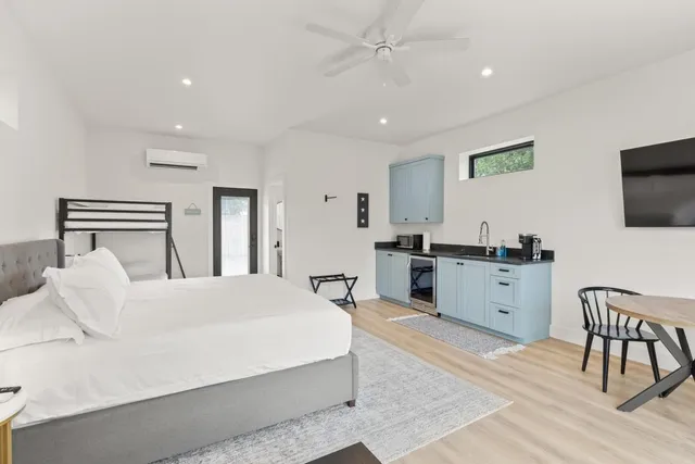 a bedroom with a bed and a flat screen tv