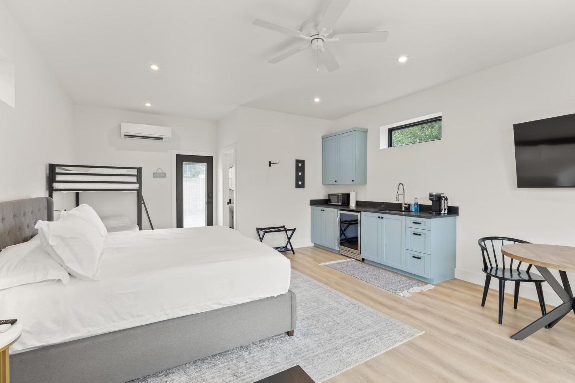 219 Bluff Street Dripping Springs, TX 78620 - Photo 29 of 40 a bedroom with a bed and a flat screen tv