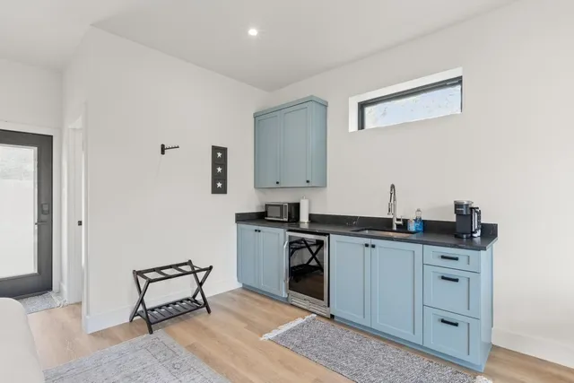 a kitchen with a sink cabinets and wooden floor