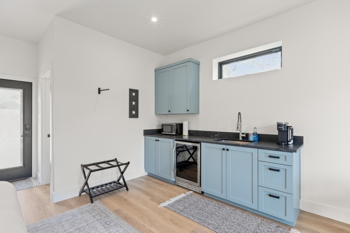 219 Bluff Street Dripping Springs, TX 78620 - Photo 30 of 40 a kitchen with a sink cabinets and wooden floor