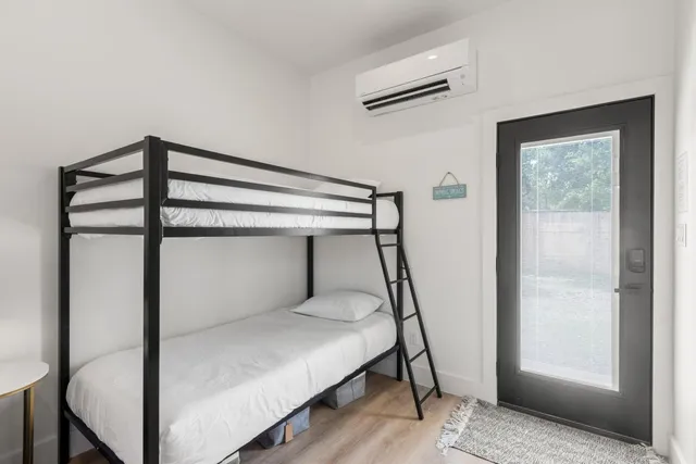 a bedroom with a bed and a window