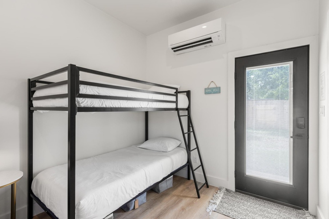 219 Bluff Street Dripping Springs, TX 78620 - Photo 31 of 40 a bedroom with a bed and a window