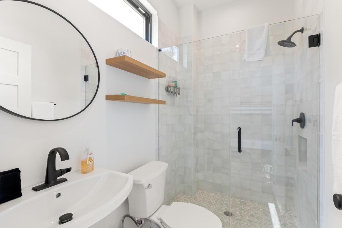 219 Bluff Street Dripping Springs, TX 78620 - Photo 32 of 40 a bathroom with a sink and a mirror