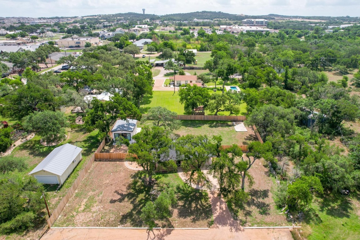 219 Bluff Street Dripping Springs, TX 78620 - Photo 36 of 40 an aerial view of residential houses with outdoor space and trees