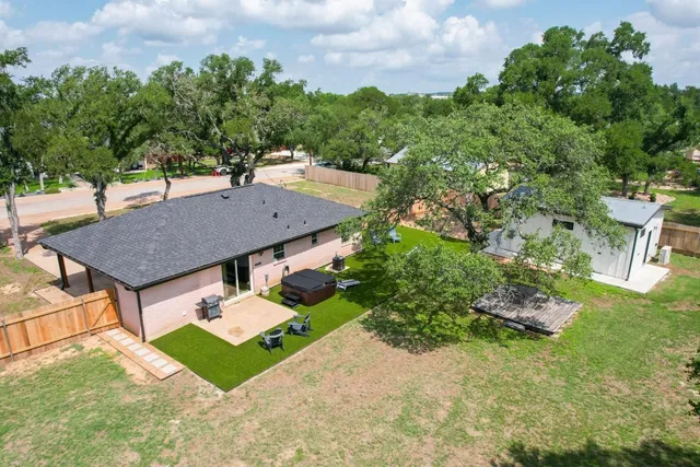 an aerial view of a house with garden space and street view