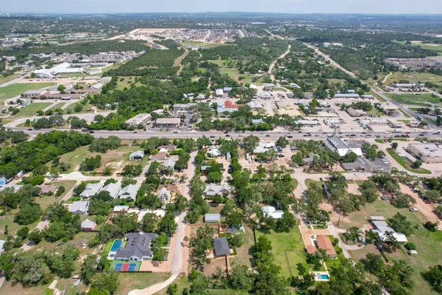 an aerial view of residential houses with outdoor space