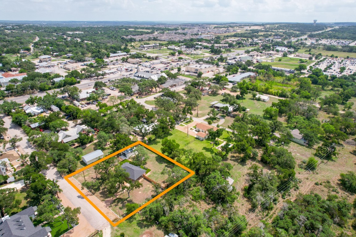 219 Bluff Street Dripping Springs, TX 78620 - Photo 40 of 40 an aerial view of residential houses with outdoor space and trees
