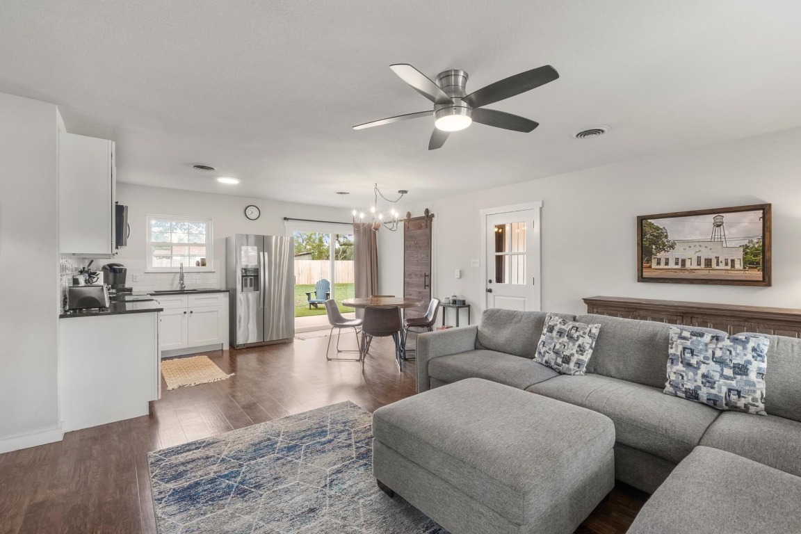 219 Bluff Street Dripping Springs, TX 78620 - Photo 6 of 40 a living room with furniture wooden floor and kitchen view