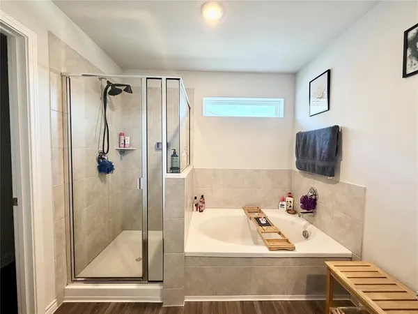 a bathroom with a tub and shower