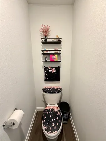 a bathroom with a toilet and a mirror