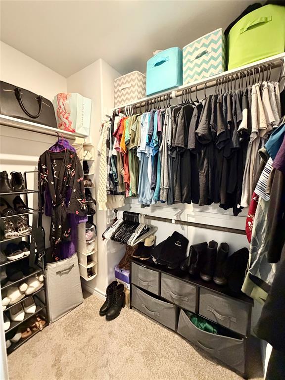 5664 Shore Point Trail Fort Worth, TX 76119 - Photo 18 of 29 a view of walk in closet with clothes and shoes
