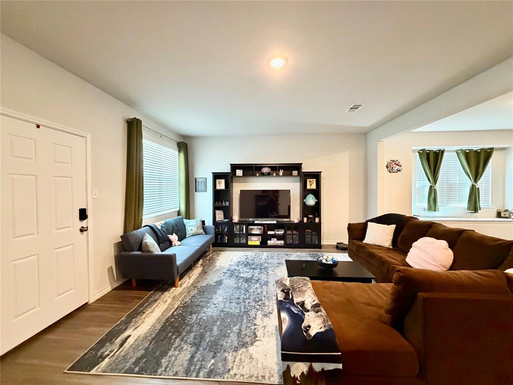 5664 Shore Point Trail Fort Worth, TX 76119 - Photo 2 of 29 a living room with furniture and a flat screen tv