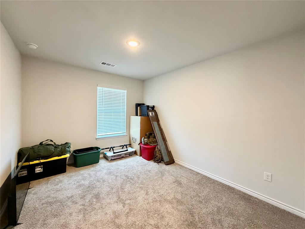 5664 Shore Point Trail Fort Worth, TX 76119 - Photo 21 of 29 a view of a room with gym equipment