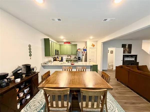 a large kitchen with a table and chairs in it