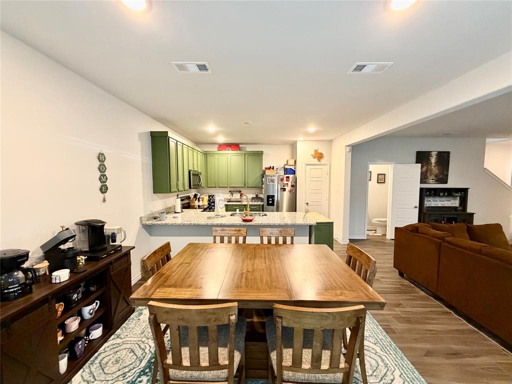 5664 Shore Point Trail Fort Worth, TX 76119 - Photo 4 of 29 a large kitchen with a table and chairs in it