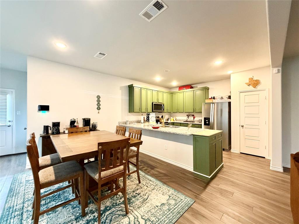 5664 Shore Point Trail Fort Worth, TX 76119 - Photo 5 of 29 a large kitchen with a table and chairs