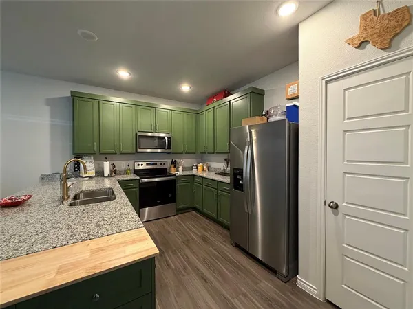 a kitchen with a refrigerator and a sink