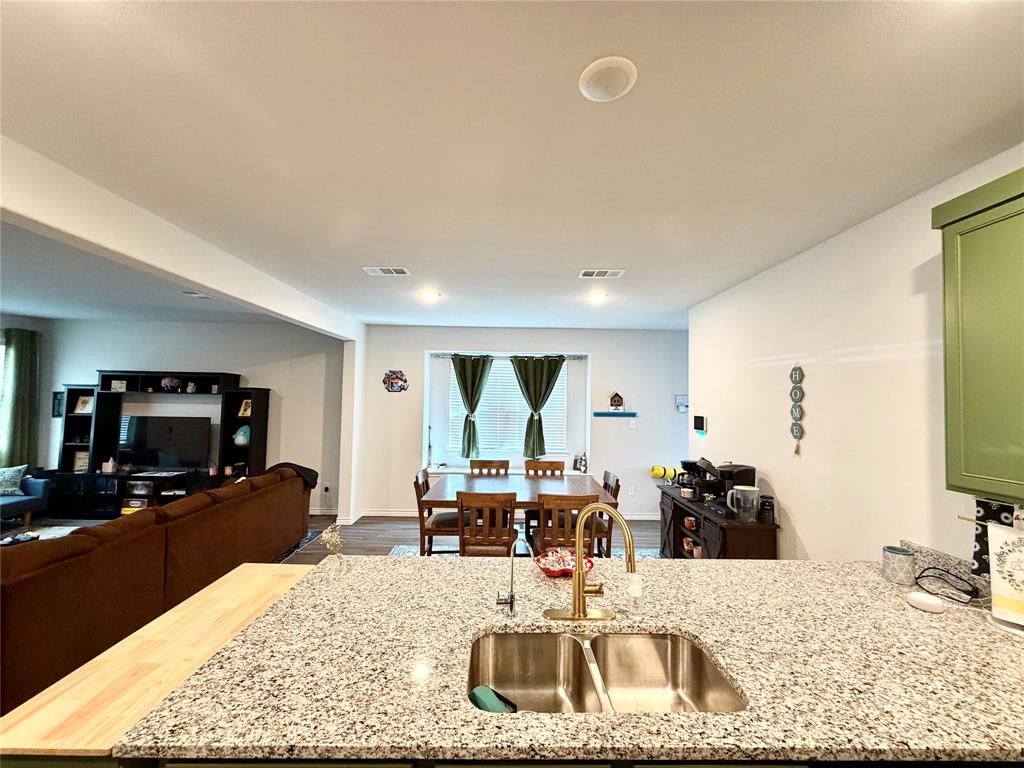 5664 Shore Point Trail Fort Worth, TX 76119 - Photo 9 of 29 a view of a living room and a kitchen