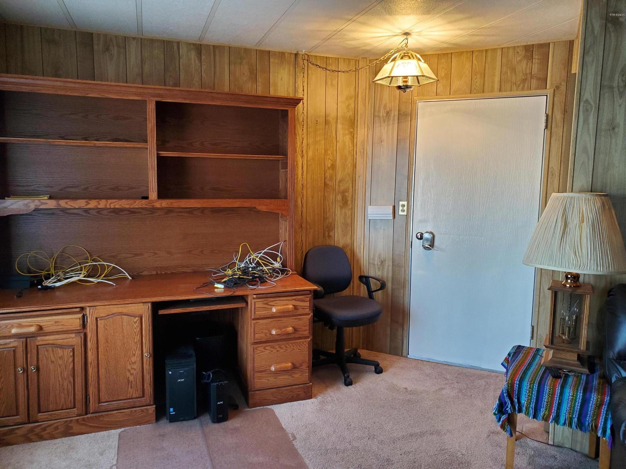 6480 Katherine Road, Unit 132 Simi Valley, CA 93063 - Photo 5 of 38 a room with a chair and a fireplace