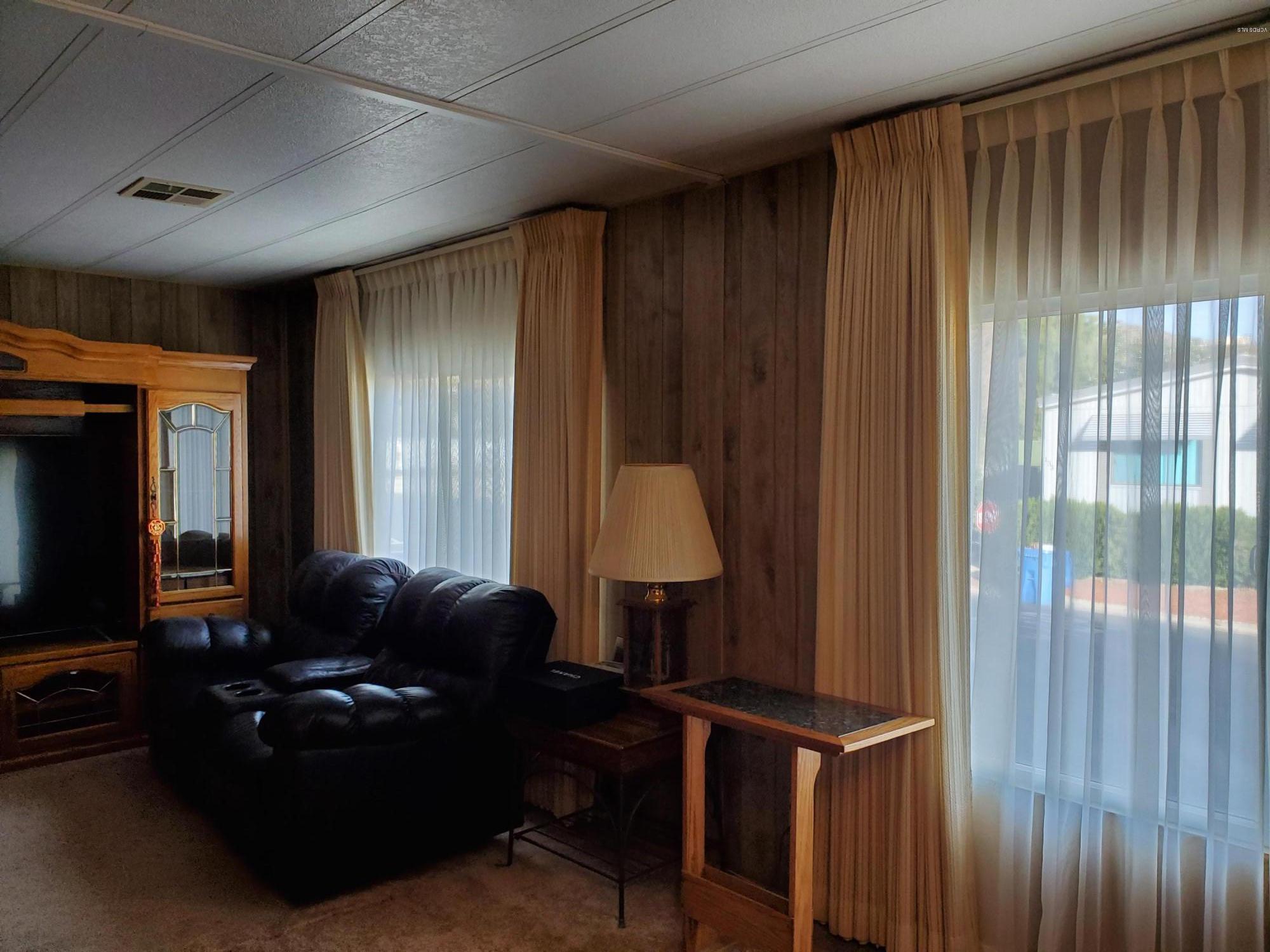6480 Katherine Road, Unit 132 Simi Valley, CA 93063 - Photo 7 of 38 a living room with furniture and a window