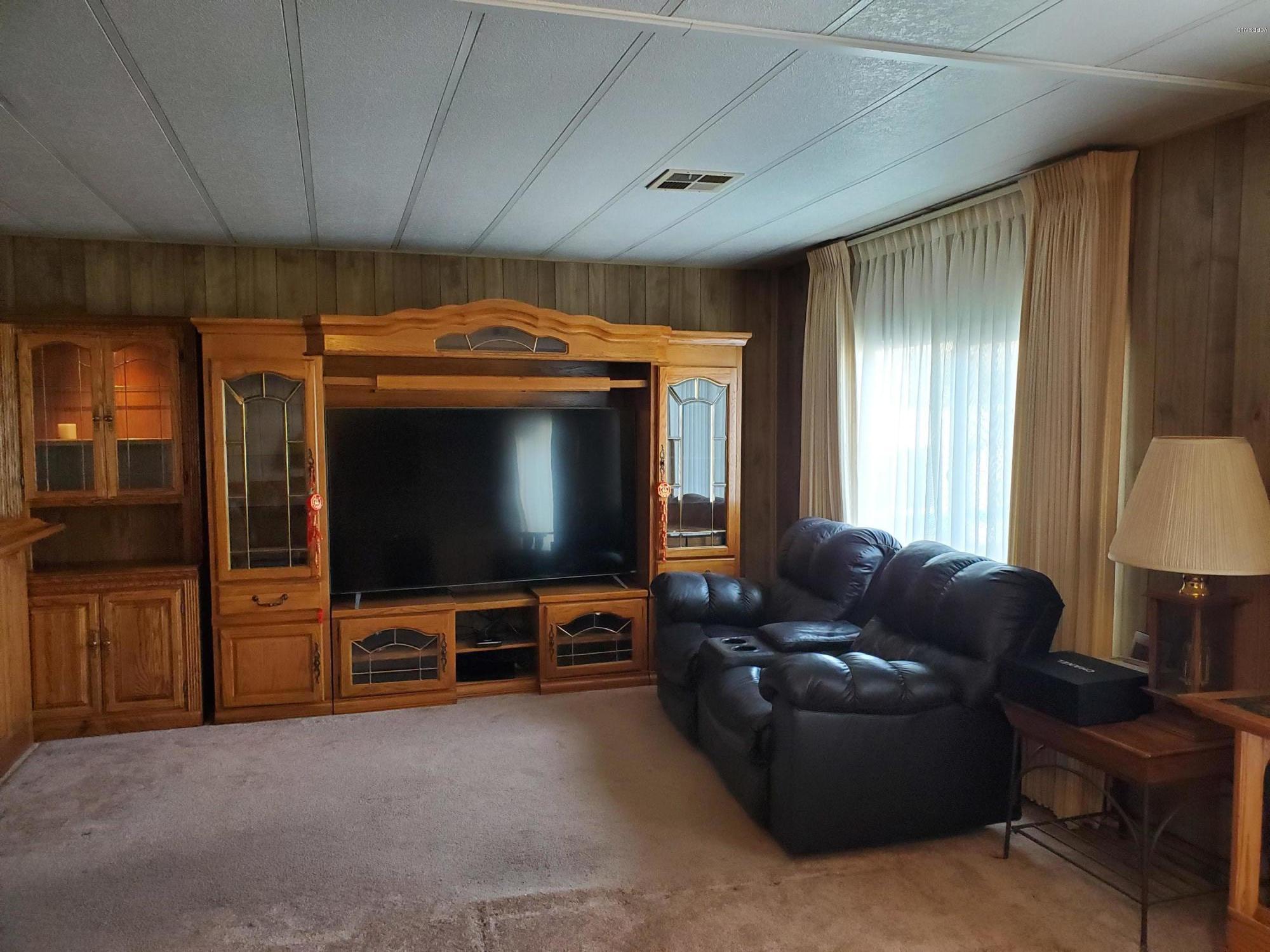 6480 Katherine Road, Unit 132 Simi Valley, CA 93063 - Photo 8 of 38 a living room with furniture and a flat screen tv