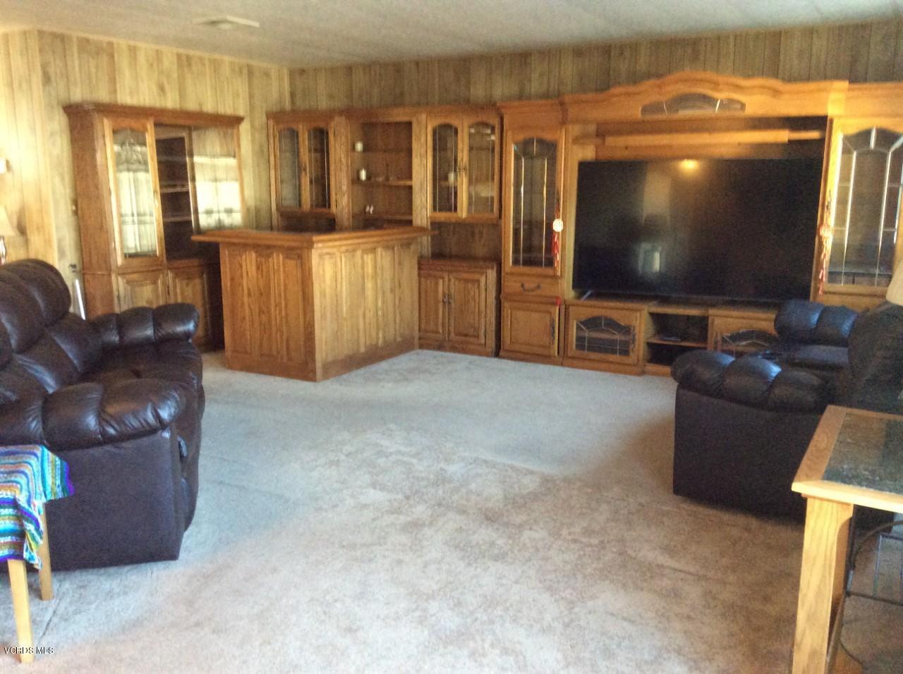 6480 Katherine Road, Unit 132 Simi Valley, CA 93063 - Photo 9 of 38 a living room with furniture and a flat screen tv