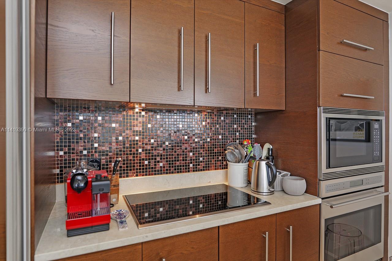 465 Brickell Avenue, Unit 2001 Miami, FL 33131 - Photo 21 of 62 a kitchen with an oven a stove and cabinets