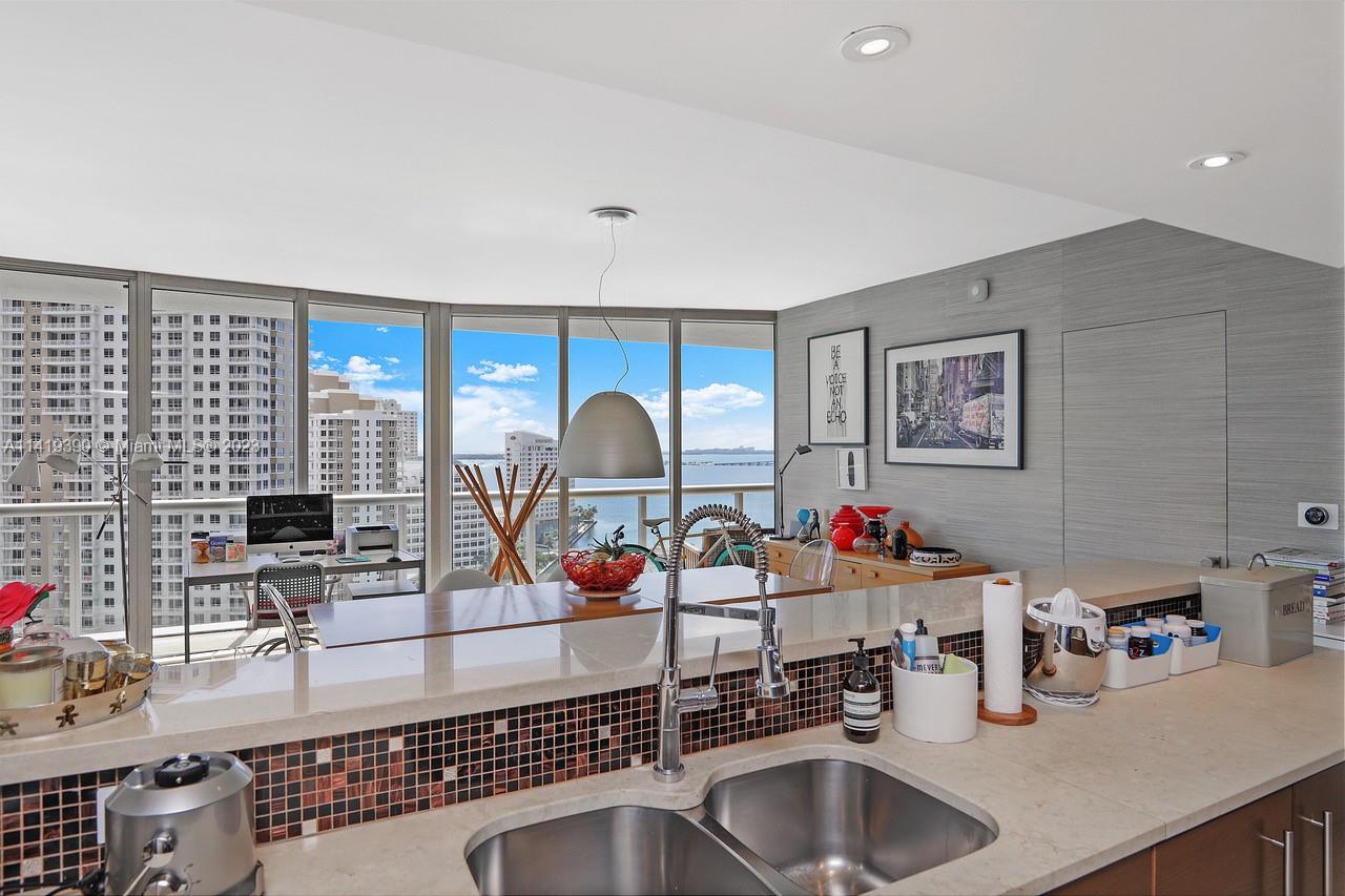 465 Brickell Avenue, Unit 2001 Miami, FL 33131 - Photo 22 of 62 a kitchen with sink a stove and cabinets