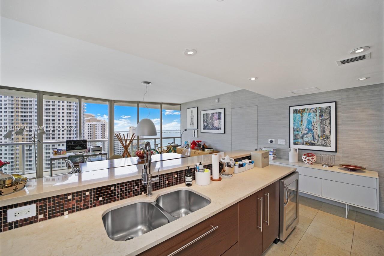 465 Brickell Avenue, Unit 2001 Miami, FL 33131 - Photo 23 of 62 a kitchen with a sink stove and cabinets