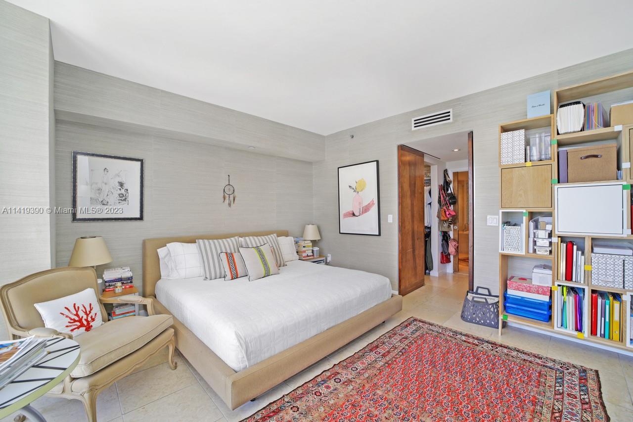 465 Brickell Avenue, Unit 2001 Miami, FL 33131 - Photo 25 of 62 a bedroom with a bed and a book shelf