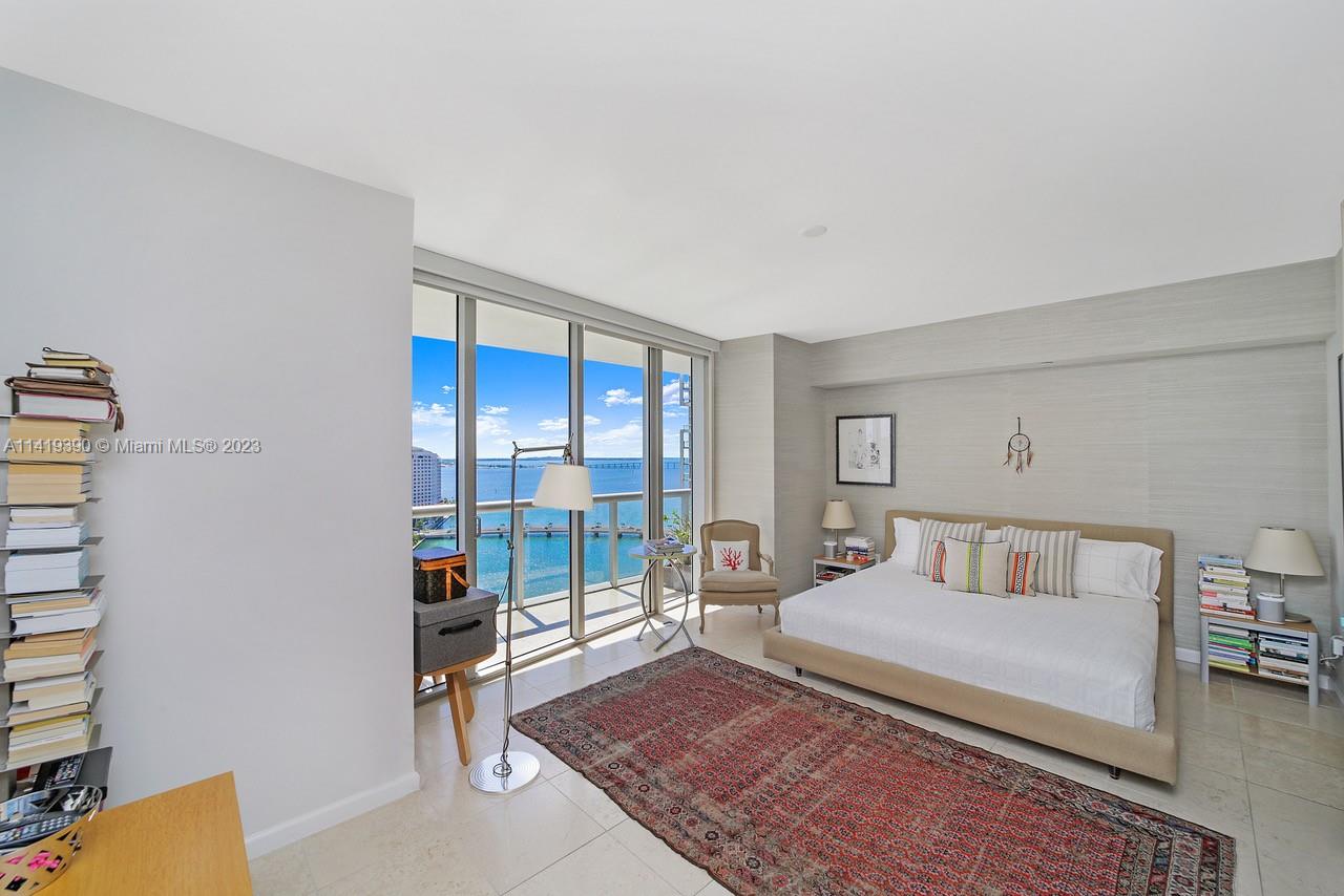 465 Brickell Avenue, Unit 2001 Miami, FL 33131 - Photo 30 of 62 a bedroom with a bed and glass door