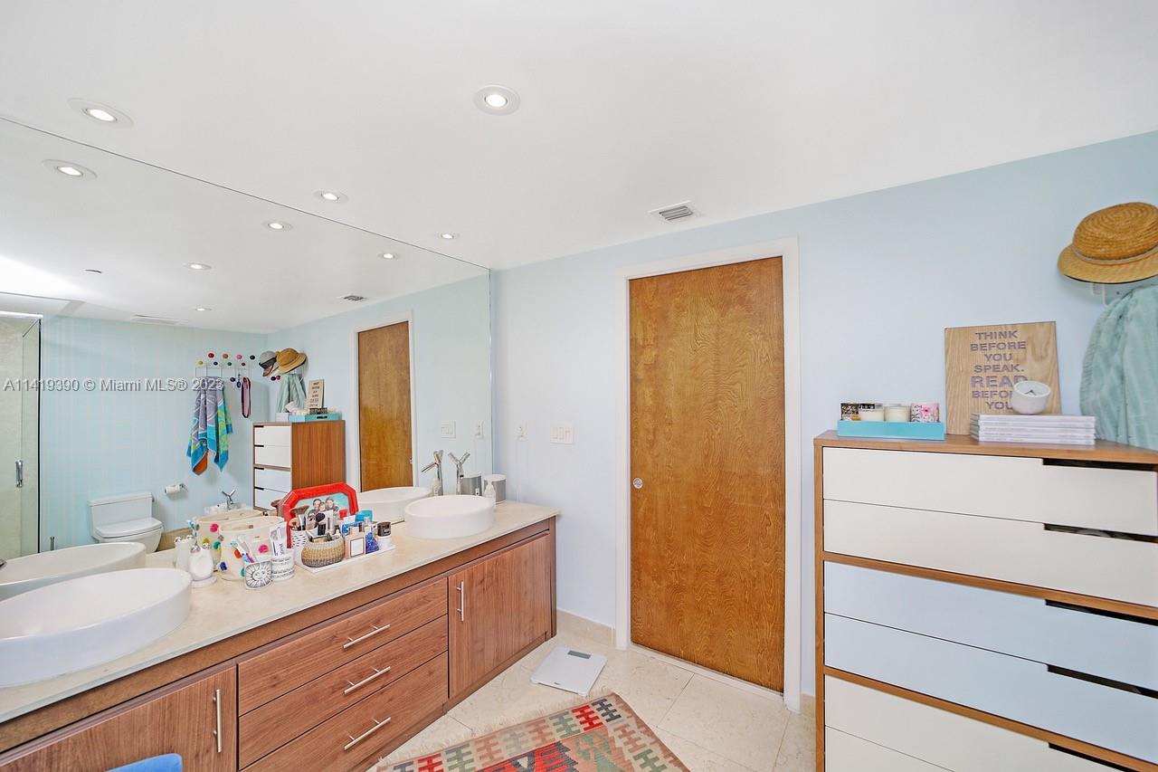 465 Brickell Avenue, Unit 2001 Miami, FL 33131 - Photo 32 of 62 a bathroom with a sink mirror and a shower