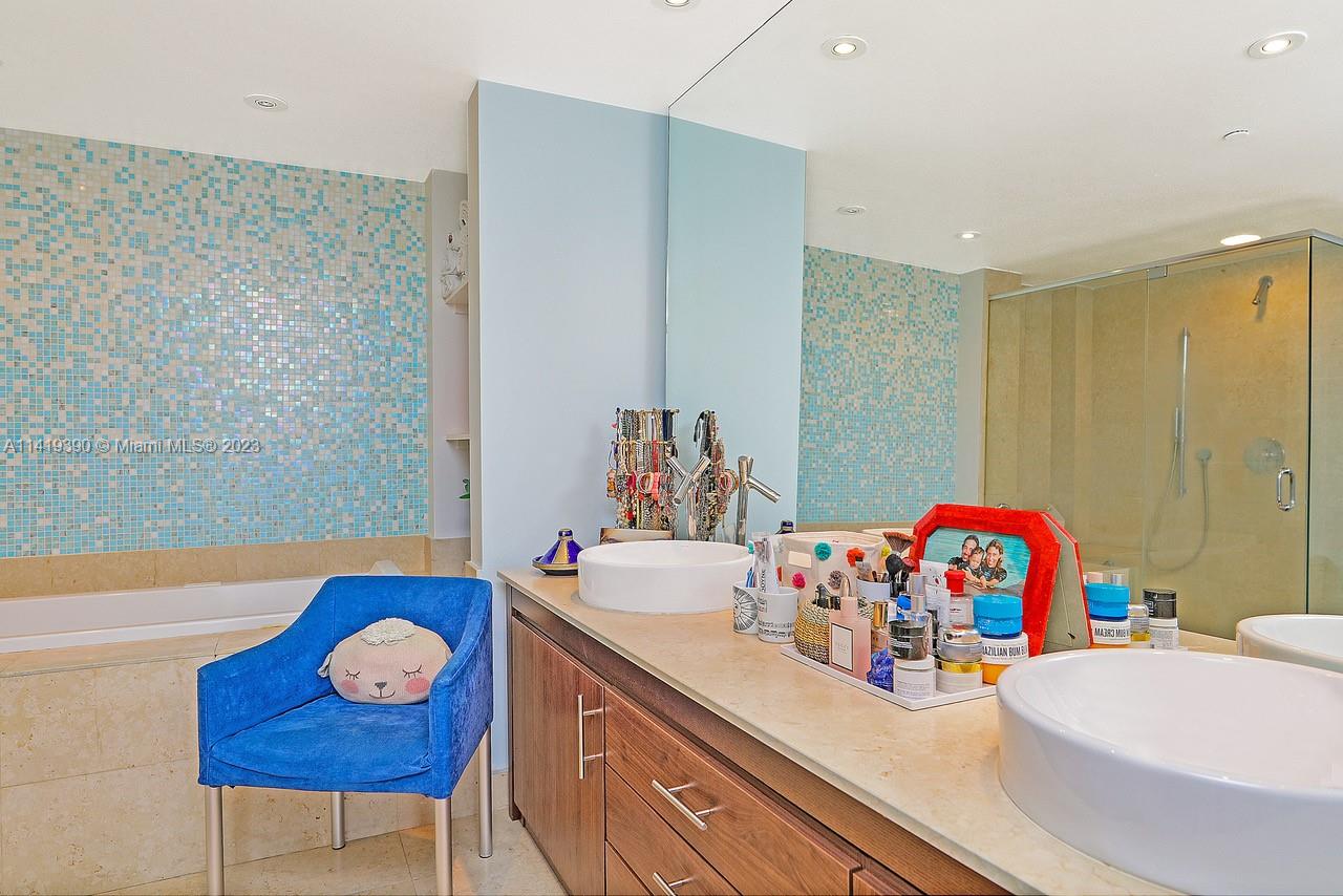 465 Brickell Avenue, Unit 2001 Miami, FL 33131 - Photo 33 of 62 a bathroom with a sink a tub and a mirror