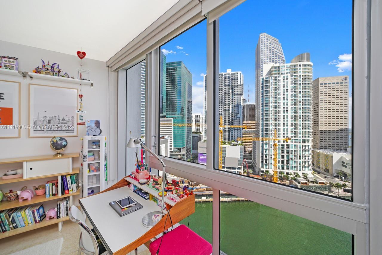 465 Brickell Avenue, Unit 2001 Miami, FL 33131 - Photo 38 of 62 a living room filled with furniture and a book shelf
