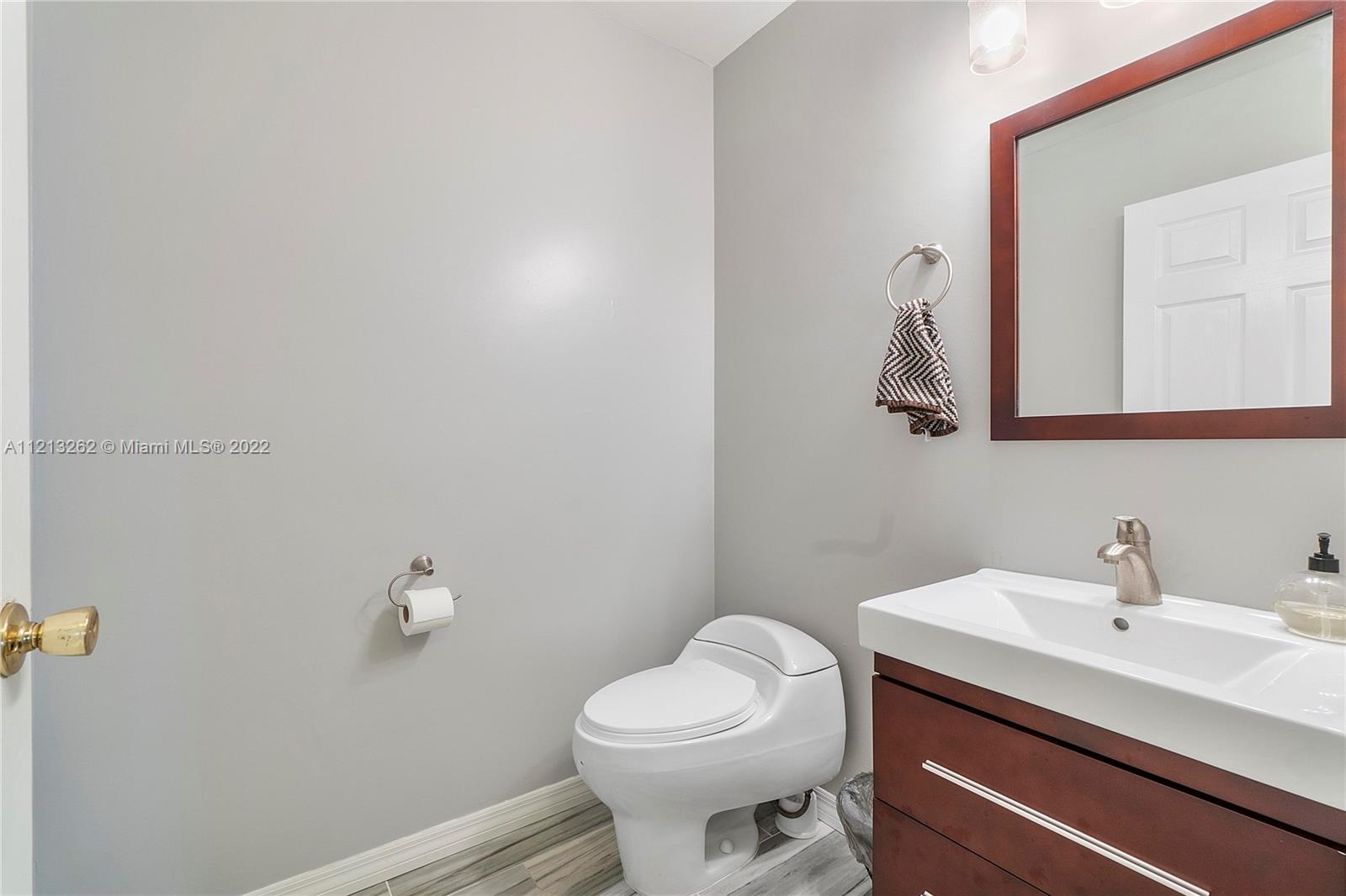 3123 Sunset Circle Margate, FL 33063 - Photo 18 of 58 a bathroom with a sink a toilet and mirror