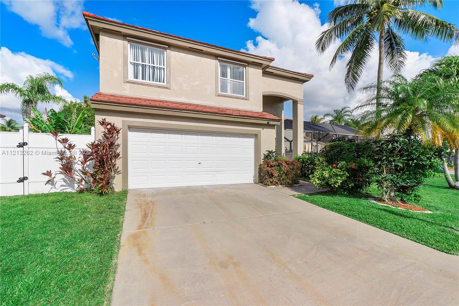 3123 Sunset Circle Margate, FL 33063 - Photo 2 of 58 a front view of a house with a yard and a garage