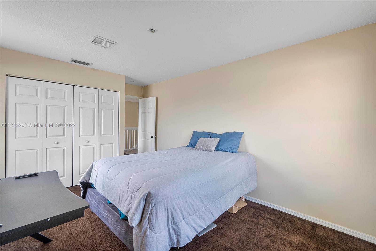 3123 Sunset Circle Margate, FL 33063 - Photo 26 of 58 a bedroom with a bed and a cabinet