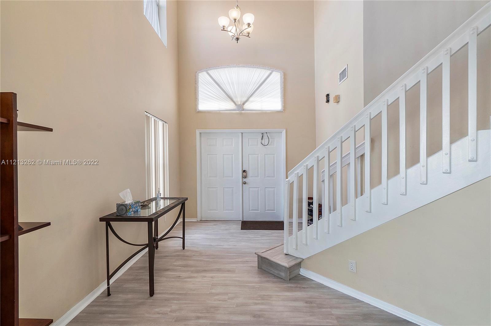 3123 Sunset Circle Margate, FL 33063 - Photo 5 of 58 a view of entryway dining room and hall with wooden floor
