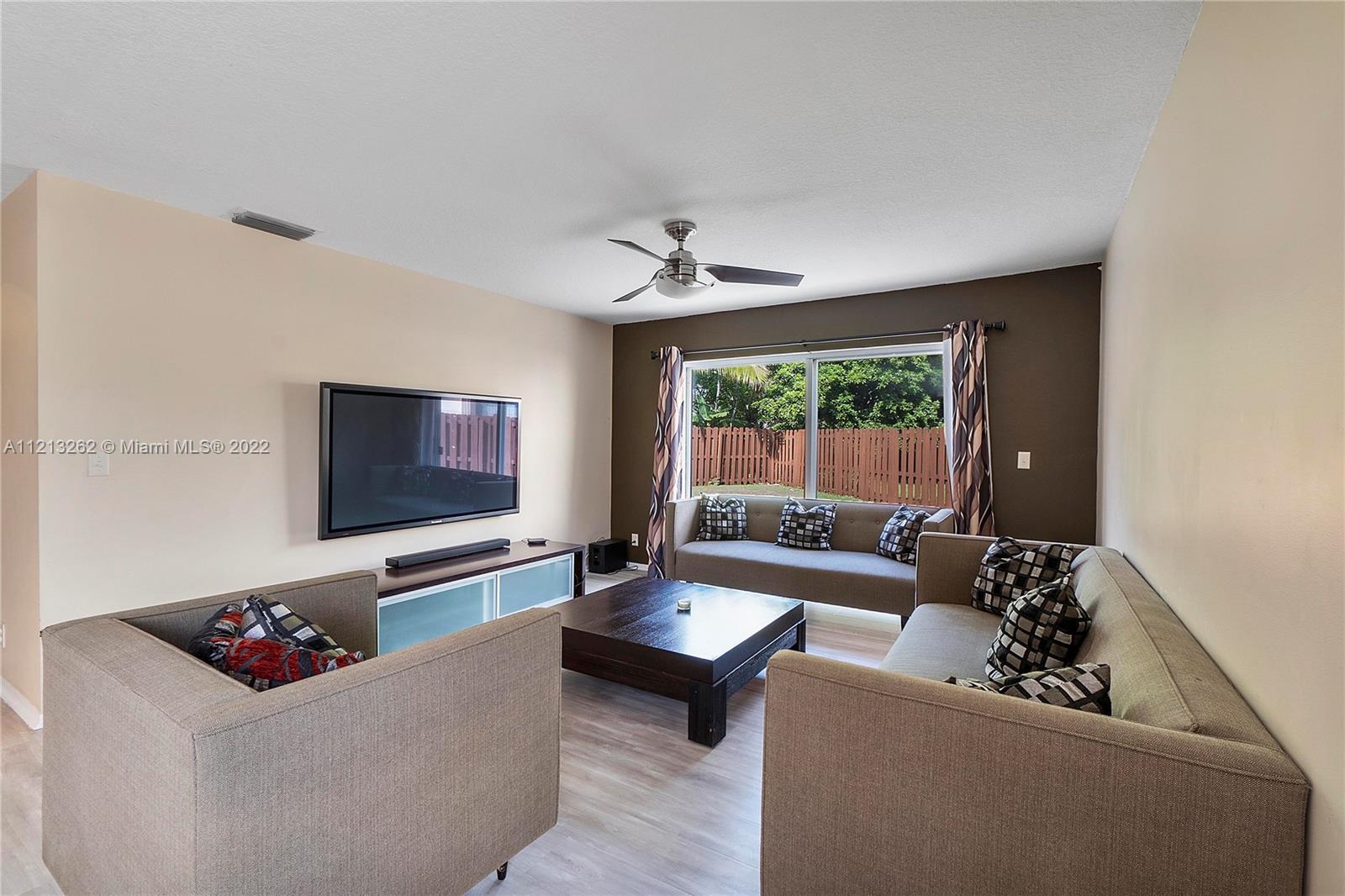 3123 Sunset Circle Margate, FL 33063 - Photo 9 of 58 a living room with furniture and a flat screen tv