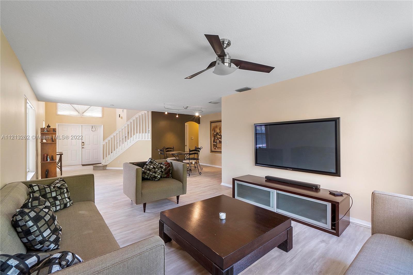 3123 Sunset Circle Margate, FL 33063 - Photo 10 of 58 a living room with furniture and a flat screen tv