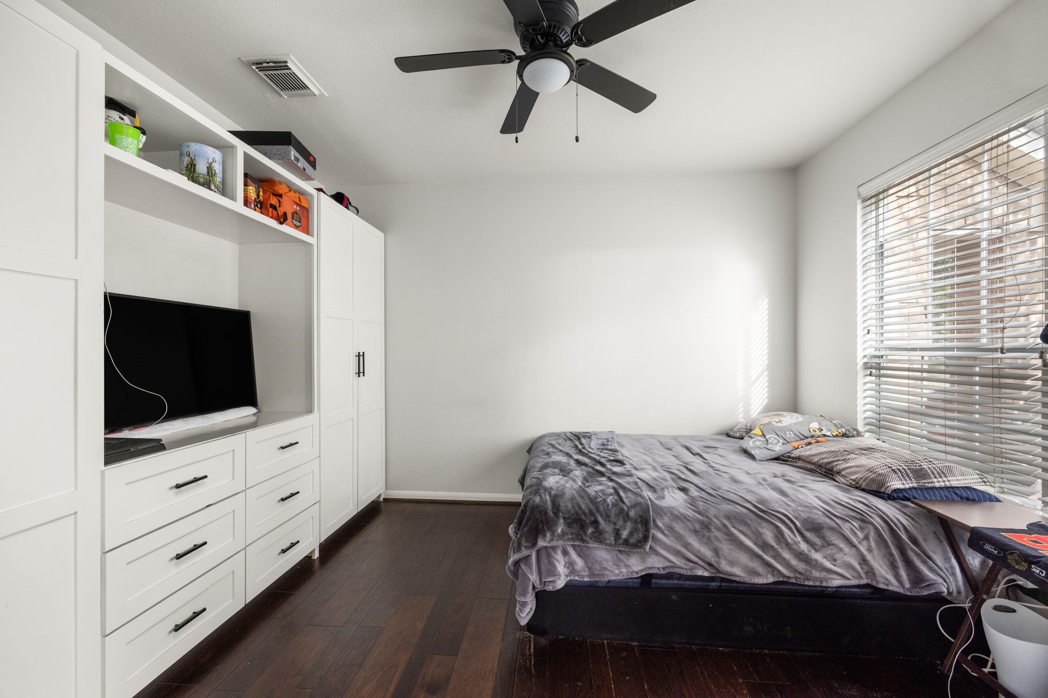 927 Spring Source Place Spring, TX 77373 - Photo 11 of 37 a bedroom with a bed and a flat tv screen on dresser